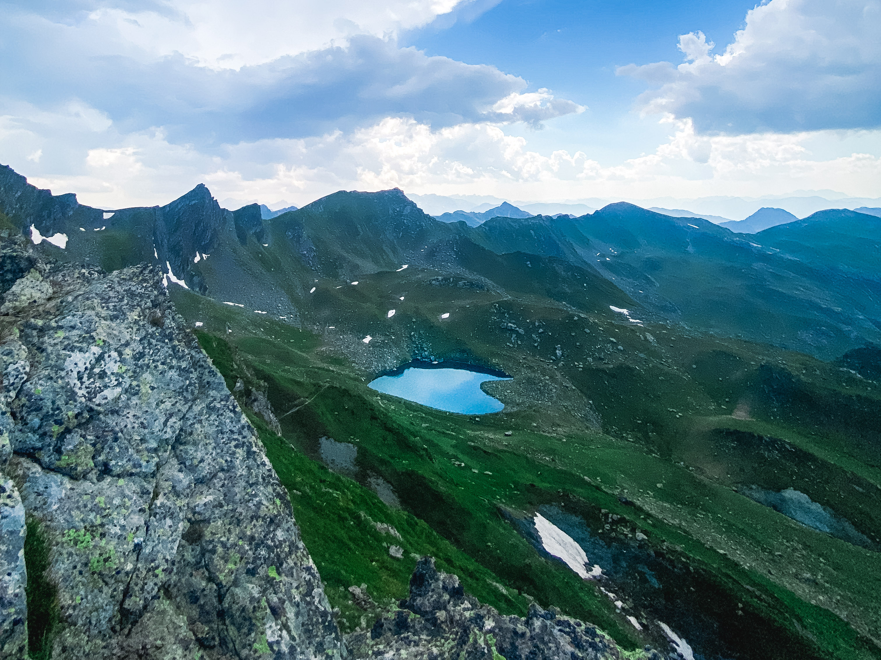 Hikers approaching Heart Lake through the rugged mountain terrain